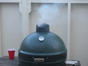 Getting the Big Green Egg up to temperature (250 degrees F). Hickory chips were added.